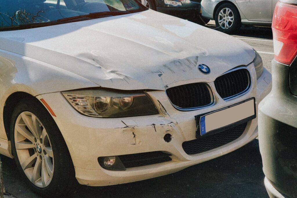 Damaged Front of A White Car