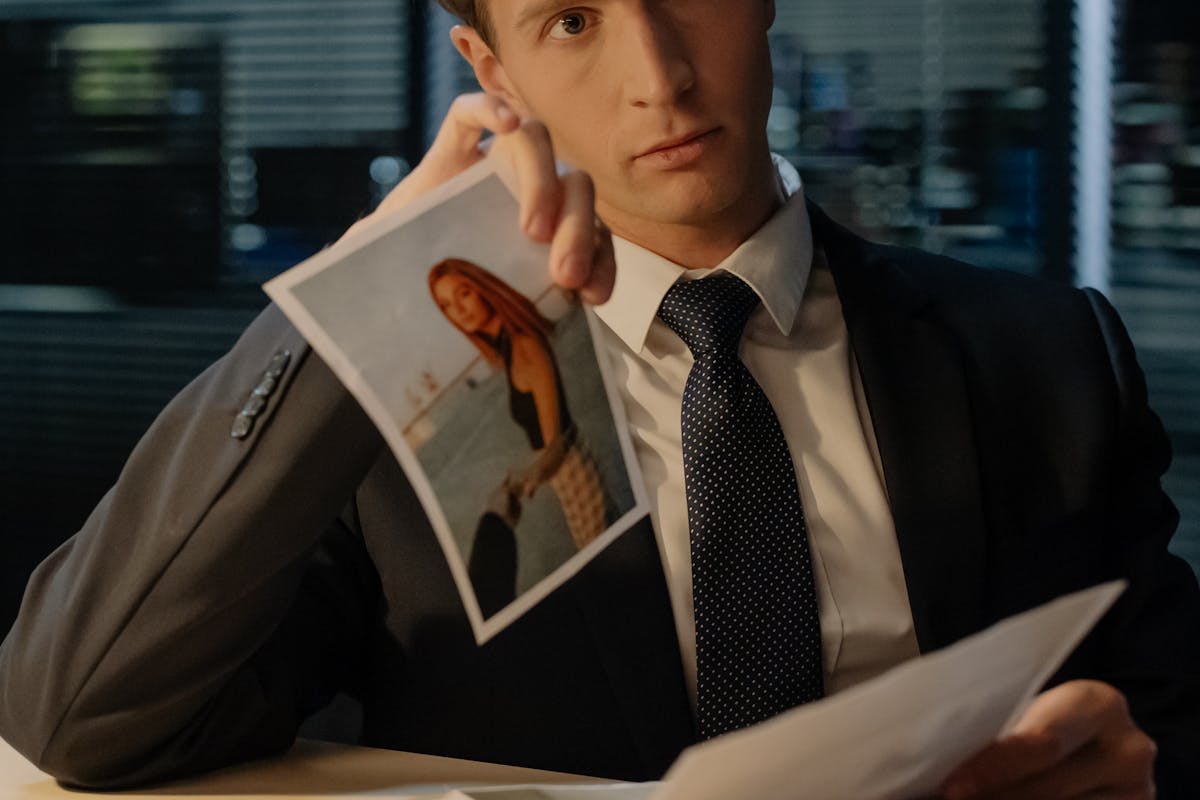 Detective Showing the Suspect Photos during an Interrogation