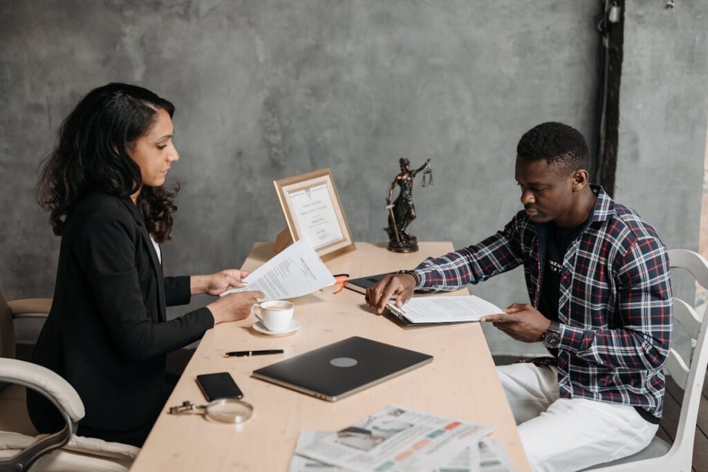 Female Lawyer and a Client looking at Documents